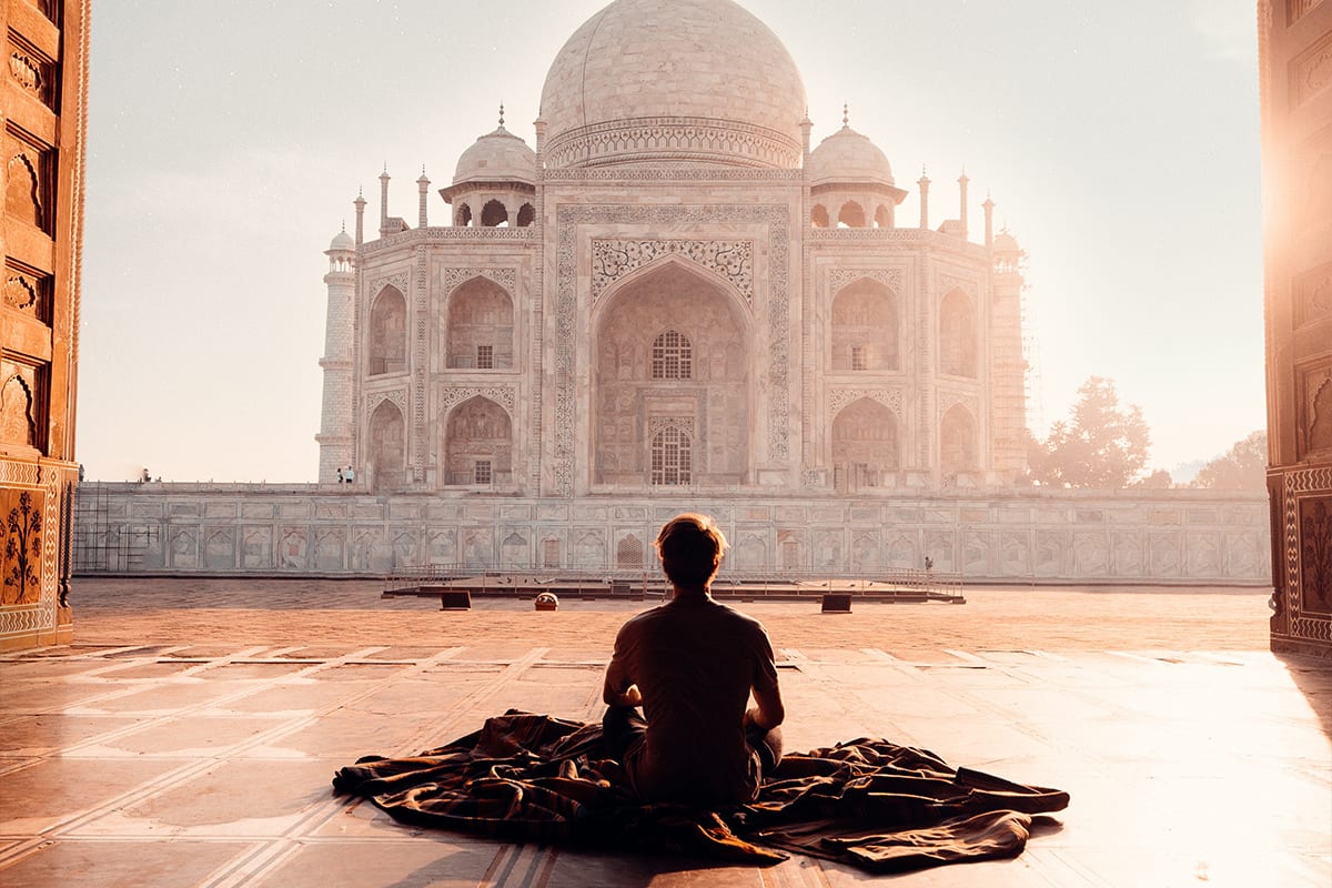 Man meditating at the Taj Mahal