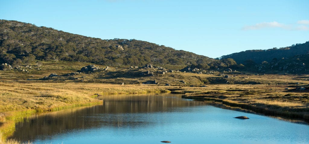 Mt Kosciuszko National Park - Shimmering lake under undulating hills