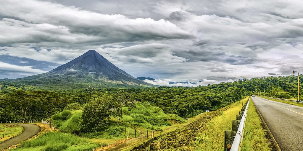 Arenal volcano rising up in the distance. Costa Rica