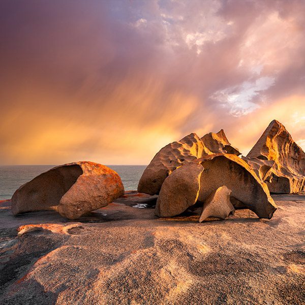 Sculptural rocks along coastline at colourful sunset. Kangaroo Island, South Australia