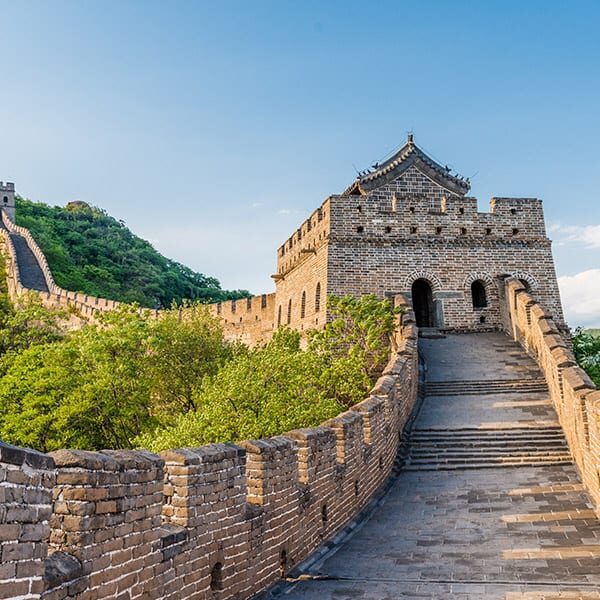 Tower along the Great Wall of China, with a view of the Great Wall snaking into the distance through the hills