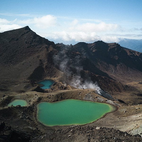 Aerial view of crater-like mountains with emerald lakes. Tongariro Lake